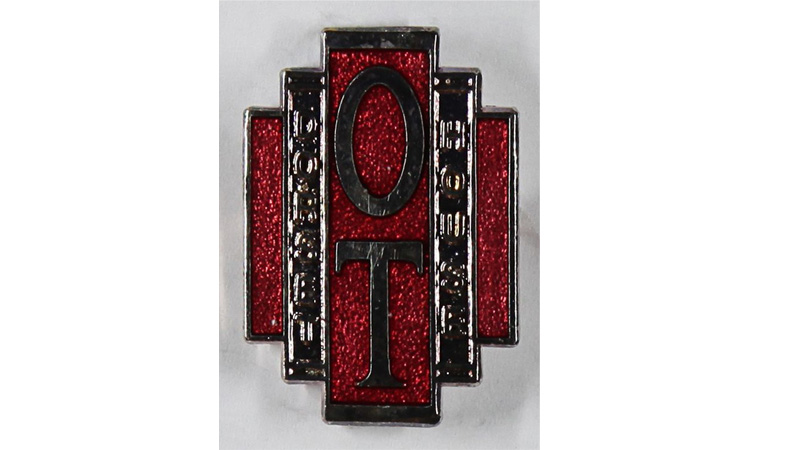 Metal and red enamel pin badge with the Dorset House logo.